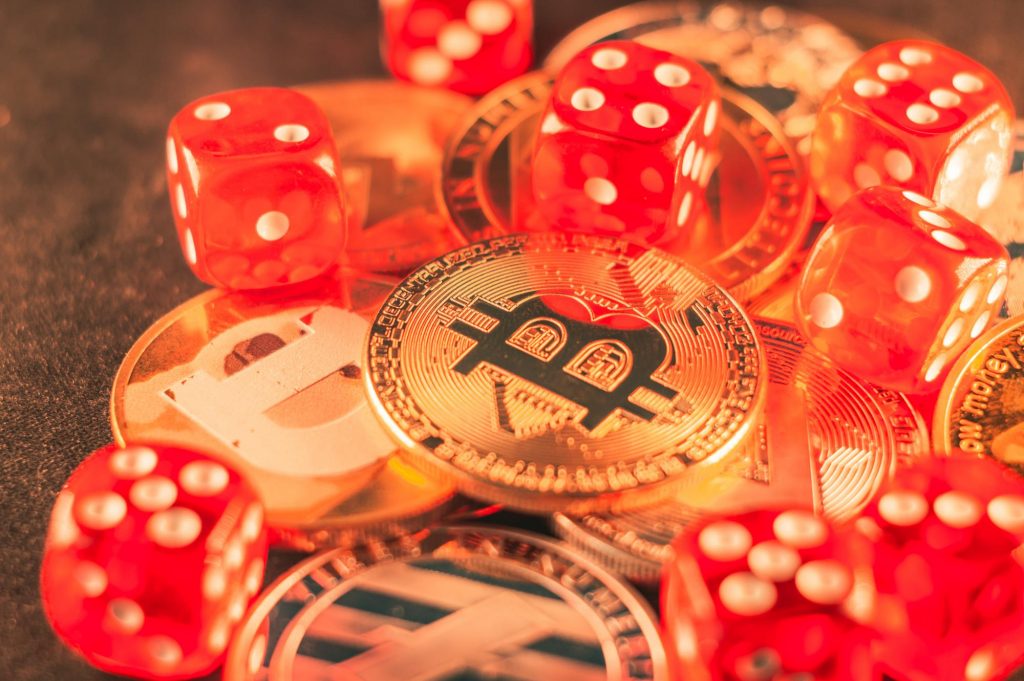 closeup-shot-of-some-bitcoins-and-red-dice
